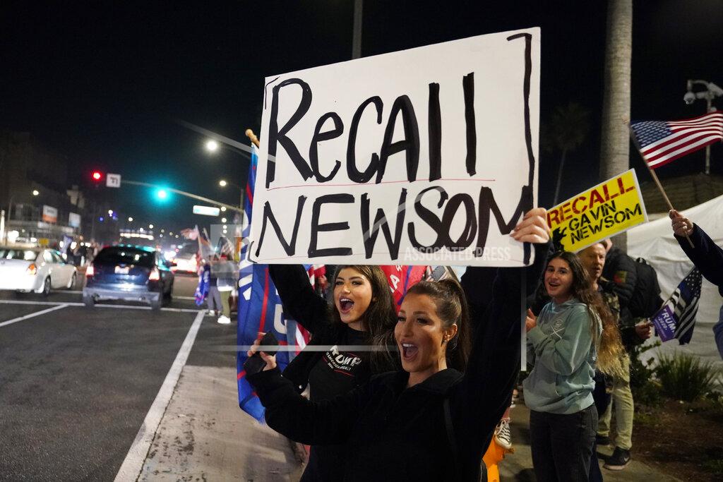 Marcio Jose Sanchez FILE - In this Nov. 21, 2020, file photo, demonstrators shout slogans while carrying a sign calling for a recall on Gov. Gavin Newsom during a protest against a stay-at-home order amid the COVID-19 pandemic in Huntington Beach, Calif. Gov. Newsom is facing a possible recall election as the nation's most populous state struggles to emerge from the coronavirus crisis. Organizers say they have collected more than half of the nearly 1.5 million petition signatures needed to place the recall on the ballot. (AP Photo/Marcio Jose Sanchez, File)