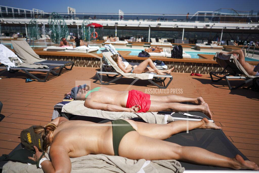 Andrew Medichini Passengers enjoy the sun by a swimming pool on board the MSC Grandiosa cruise ship in Civitavecchia, near Rome, Wednesday, March 31, 2021. MSC Grandiosa, the world's only cruise ship to be operating at the moment, left from Genoa on March 30 and stopped in Civitavecchia near Rome to pick up more passengers and then sail toward Naples, Cagliari, and Malta to be back in Genoa on April 6. For most of the winter, the MSC Grandiosa has been a lonely flag-bearer of the global cruise industry stalled by the pandemic, plying the Mediterranean Sea with seven-night cruises along Italy’s western coast, its major islands and a stop in Malta. (AP Photo/Andrew Medichini)