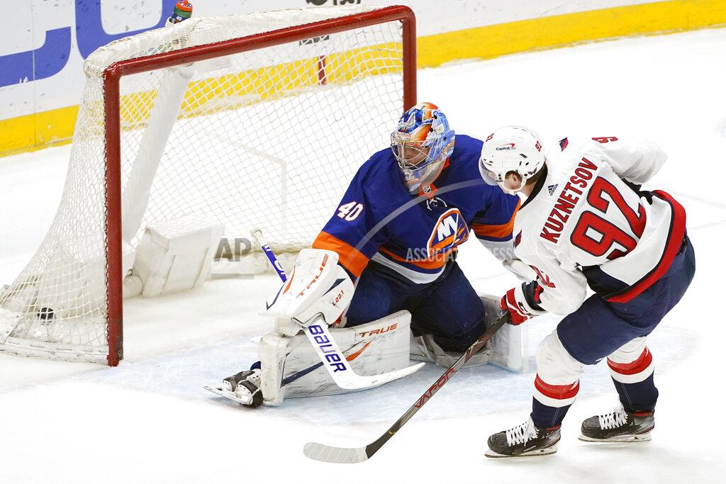 Kathy Willens Washington Capitals center Evgeny Kuznetsov (92) and New York Islanders goaltender Semyon Varlamov (40) look into the net after Kuznesov scored in the shootout of an NHL hockey game,Thursday, April 22, 2021, in Uniondale, N.Y. The Capitals won 1-0. (AP Photo/Kathy Willens)