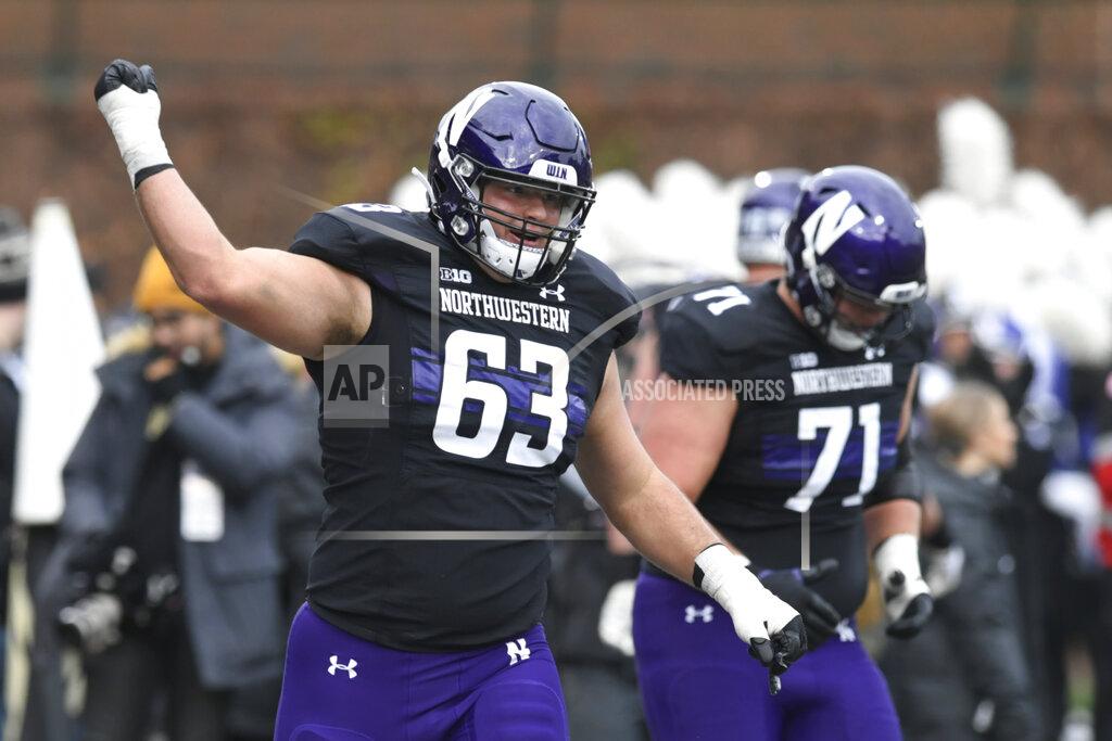 Paul Beaty Northwestern's Dom D'Antonio (63) celebrates after teammate Marshall Lang (88) caught a touchdown pass during the first half of a NCAA football game against Purdue Nov. 20, 2021 at Wrigley Field in Chicago. Purdue won 32-14. (AP Photo/Paul Beaty)