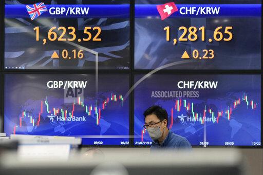 A currency trader watches monitors at the foreign exchange dealing room of the KEB Hana Bank headquarters in Seoul, South Korea, Friday, Oct. 22, 2021. Asian shares were mixed Friday after a late-in-the-day wave of buying pushed the S&P 500 to a fresh record high. (AP Photo/Ahn Young-joon)