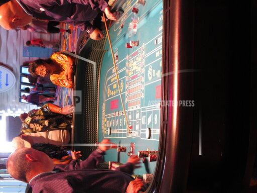 Wayne Parry FILE - Gamblers play a game of craps at the Ocean Casino Resort in Atlantic City N.J., in this June 18, 2019, file photo. On April 6, 2021, Luxor Capital, the New York hedge fund that owns the casino, told The Associated Press it is selling an ownership interest of up to 50% in the casino to the Ilitch family of Detroit, which owns professional sports teams, the Little Caesars pizza chain, and a Detroit casino. (AP Photo/Wayne Parry, File)