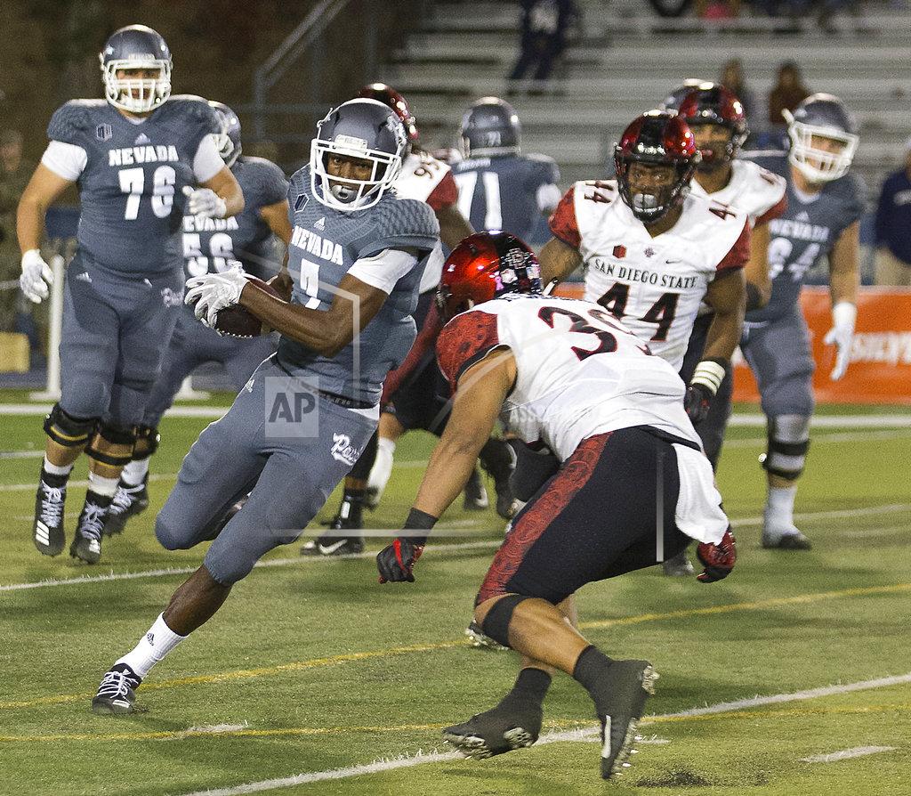 Tom R. Smedes Nevada wide receiver Romeo Doubs (7) is hit by San Diego State's Ronley Lakalaka (39) in the second half of an NCAA college football game in Reno, Nev., Saturday, Oct. 27, 2018. (AP Photo/Tom R. Smedes)