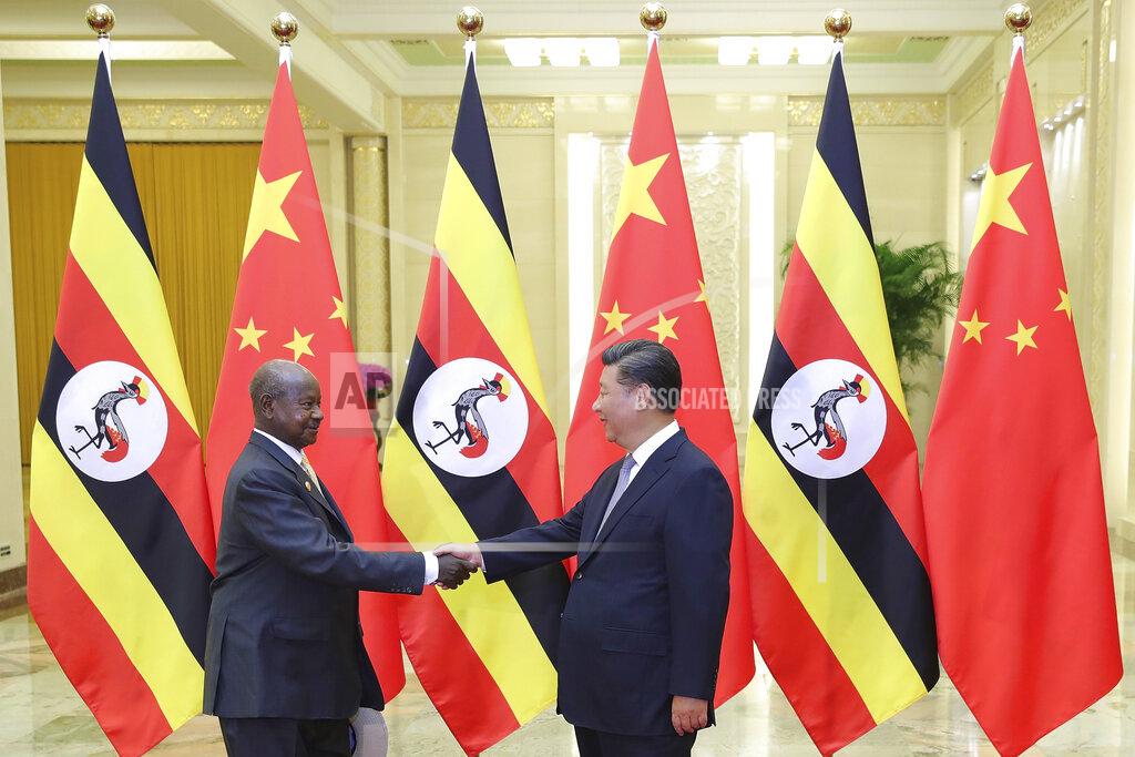 Lintao Zhang FILE - In this Thursday, Sept. 6, 2018 file photo, China's President Xi Jinping, right, shakes hands with Uganda's President Yoweri Museveni at the Great Hall of the People in Beijing, China. African leaders in 2020 are asking what China can do for them as the coronavirus pandemic threatens to destroy economies across a continent where Beijing is both the top trading partner and top lender. (Lintao Zhang/Pool File Photo via AP)