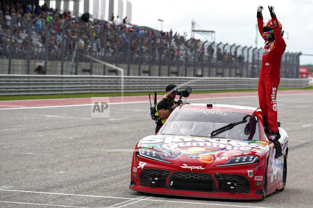 Chuck Burton Kyle Busch stands on his car as he celebrates after winning the NASCAR Xfinity Series auto race at the Circuit of the Americas in Austin, Texas, Saturday, May 22, 2021. (AP Photo/Chuck Burton)