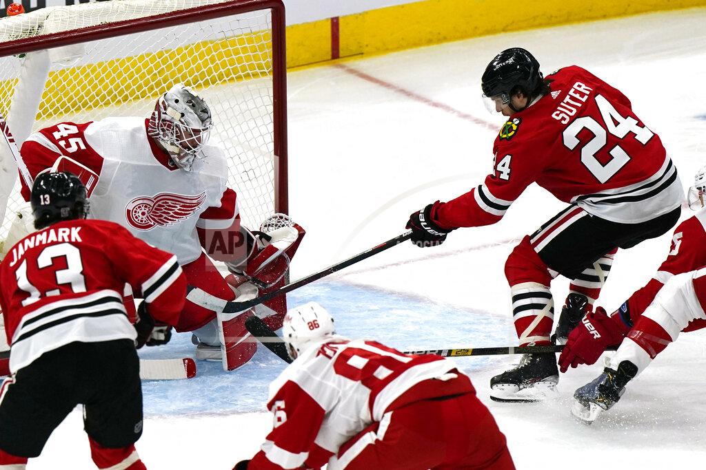 Nam Y. Huh Chicago Blackhawks center Pius Suter, right, scores his second goal against Detroit Red Wings goalie Jonathan Bernier during the first period of an NHL hockey game in Chicago, Sunday, Jan. 24, 2021. (AP Photo/Nam Y. Huh)
