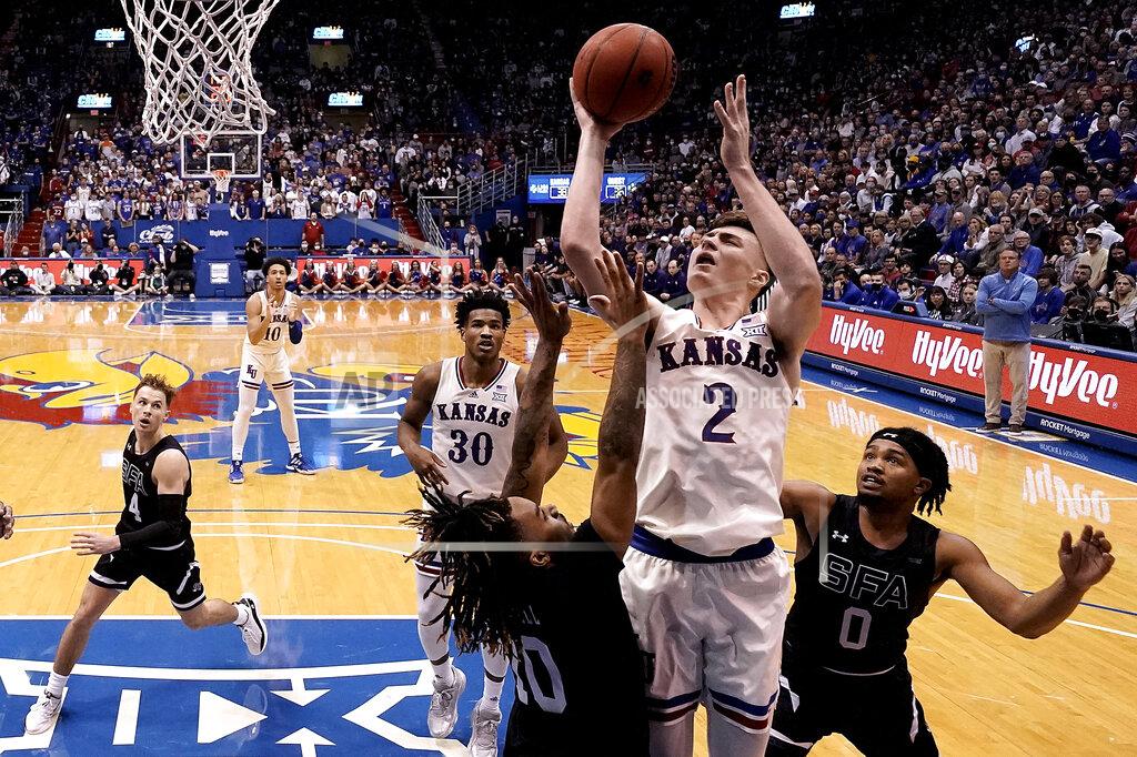 Charlie Riedel Kansas' Christian Braun (2) shoots over Stephen F. Austin's Latrell Jossell (10) during the second half of an NCAA college basketball game Saturday, Dec. 18, 2021, in Lawrence, Kan. (AP Photo/Charlie Riedel)