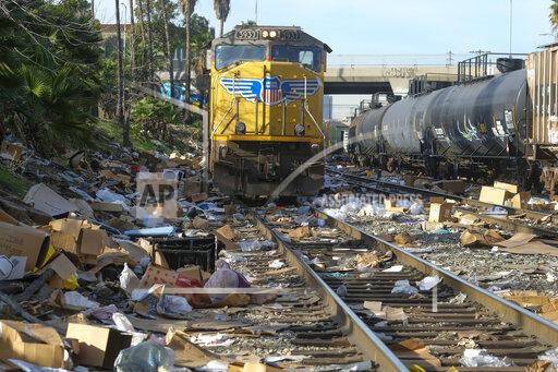 Shredded boxes and packages are seen at a section of the Union Pacific train tracks in downtown Los Angeles Friday, Jan. 14, 2022. Thieves have been raiding cargo containers aboard trains nearing downtown Los Angeles for months, leaving the tracks blanketed with discarded packages. The sea of debris left behind included items that the thieves apparently didn't think were valuable enough to take, CBSLA reported Thursday. (AP Photo/Ringo H.W. Chiu)