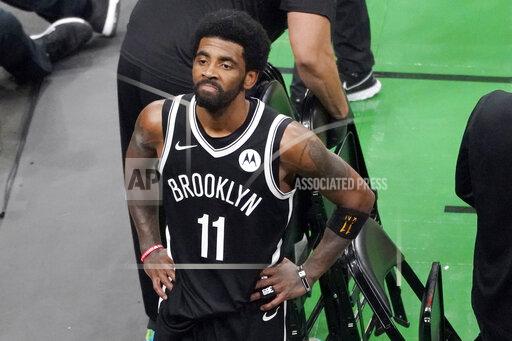 FILE - Brooklyn Nets guard Kyrie Irving looks up at the fans at TD Garden after they defeated the Boston Celtics in Game 4 during an NBA basketball first-round playoff series in Boston, in this Sunday, May 30, 2021, file photo. The Brooklyn Nets won't play Kyrie Irving until he can play in all their games, unwilling to let questions about his vaccination status linger into the season. The Nets announced Tuesday, Oct. 12, 2021, that Irving would not play or practice with them until he could be a full participant, ending the idea that he would play in only road games. Without mentioning his vaccination status, general manager Sean Marks said Irving has made a decision that keeps him from being able to perform with the team. (AP Photo/Elise Amendola, File)