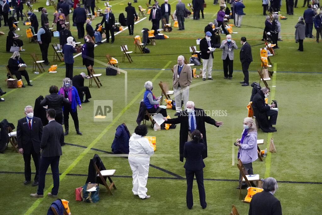 Charles Krupa Legislators gather prior to a New Hampshire House of Representatives legislative session held at NH Sportsplex, due to the coronavirus, Wednesday, Feb. 24, 2021, in Bedford, N.H. (AP Photo/Charles Krupa)