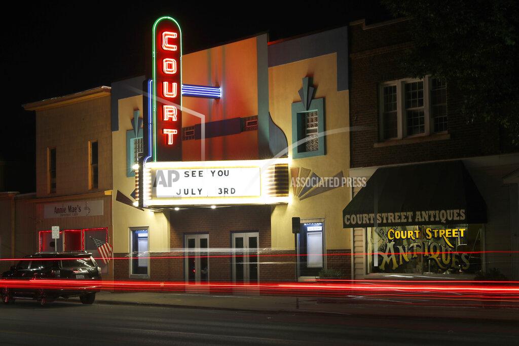 Charles Rex Arbogast Traffic passes by the Court Street Theatre Monday, June 29, 2020, as the marque signals its reopening date in Saginaw, Mich. The unemployment rate around Saginaw is now 25.6%. (AP Photo/Charles Rex Arbogast)