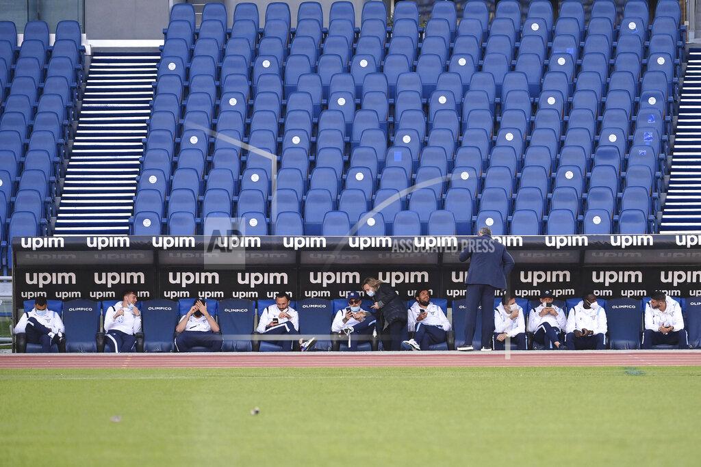 Alfredo Falcone Lazio players sit on the bench prior to the Serie A soccer match between Lazio and Torino, at the Rome Olympic Stadium Tuesday, March 2, 2021. Lazio walked out into Stadio Olimpico for its Serie A match on Tuesday even though it knows its Torino opponents are still in Turin. A coronavirus outbreak forced Torino players and staff into self-isolation that doesn't end until midnight Tuesday, hours after the scheduled kickoff against Lazio in Rome. (Alfredo Falcone/LaPresse via AP)