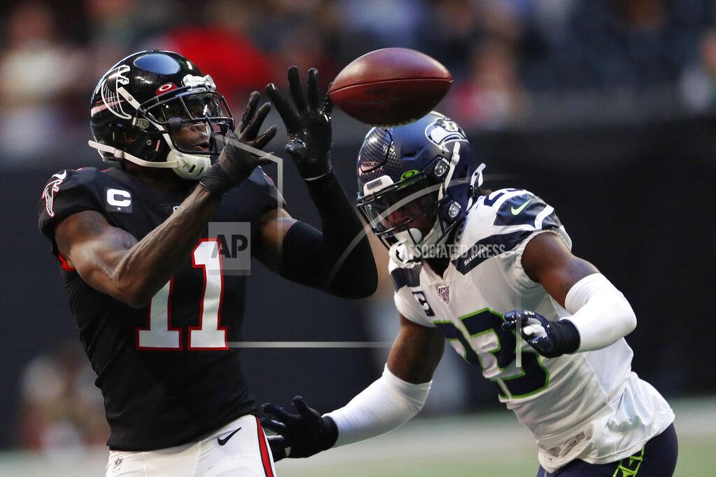 John Bazemore of Seattle Seahawks defensive back Neiko Thorpe (23) Atlanta Falcons wide receiver Julio Jones (11) makes the catch ahead during the first half of an NFL football game, Sunday, Oct. 27, 2019, in Atlanta. (AP Photo/John Bazemore)