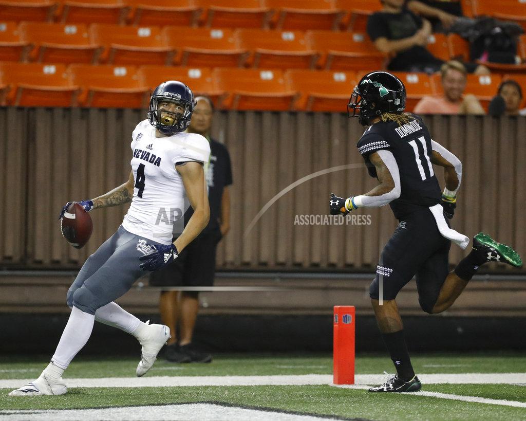 Marco Garcia Nevada wide receiver Elijah Cooks (4) makes a touchdown as Hawaii defensive back Jay Dominique (11) runs during the third quarter at an NCAA college football game Saturday, Oct. 20, 2018, in Honolulu. (AP Photo/Marco Garcia)