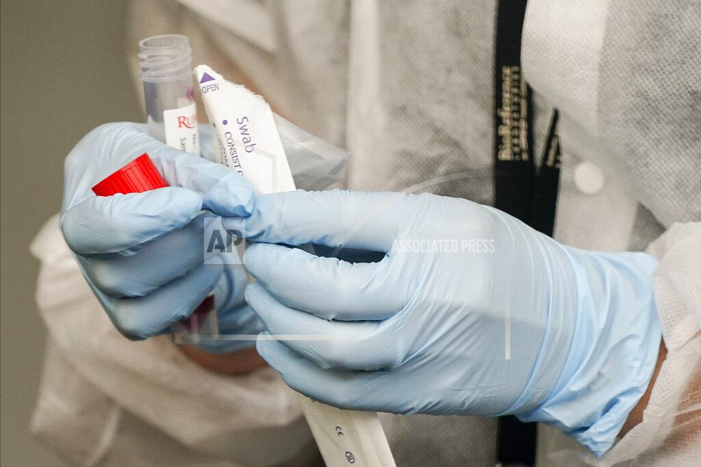 Frank Franklin Ii A Medical Assistant administers a Covid test as part of plans by the Metropolitan Transportation Authority to test workers Tuesday, Oct. 27, 2020, at the Grand Avenue Bus Depot in New York. (AP Photo/Frank Franklin II)