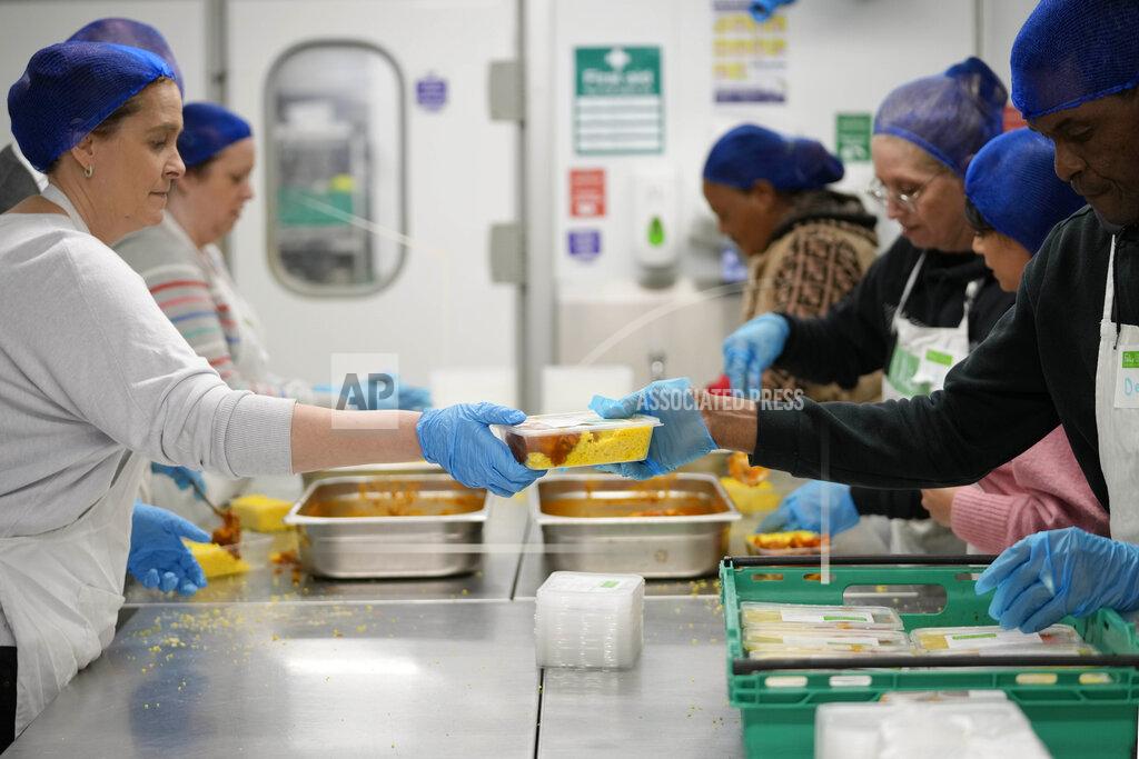 Frank Augstein Volunteers from the charity 'The Felix Project' prepare meals in the kitchen of their hub in London, Wednesday, May 4, 2022. Across Britain, food banks and community food hubs that helped struggling families, older people and the homeless during the pandemic are now seeing soaring demand. The cost of food and fuel in the U.K. has risen sharply since late last year, with inflation reaching the highest level in 40 years. (AP Photo/Frank Augstein)