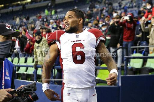 Arizona Cardinals' James Conner smiles as he heads off the field after his team defeated the Seattle Seahawks in an NFL football game, Sunday, Nov. 21, 2021, in Seattle. (AP Photo/John Froschauer)