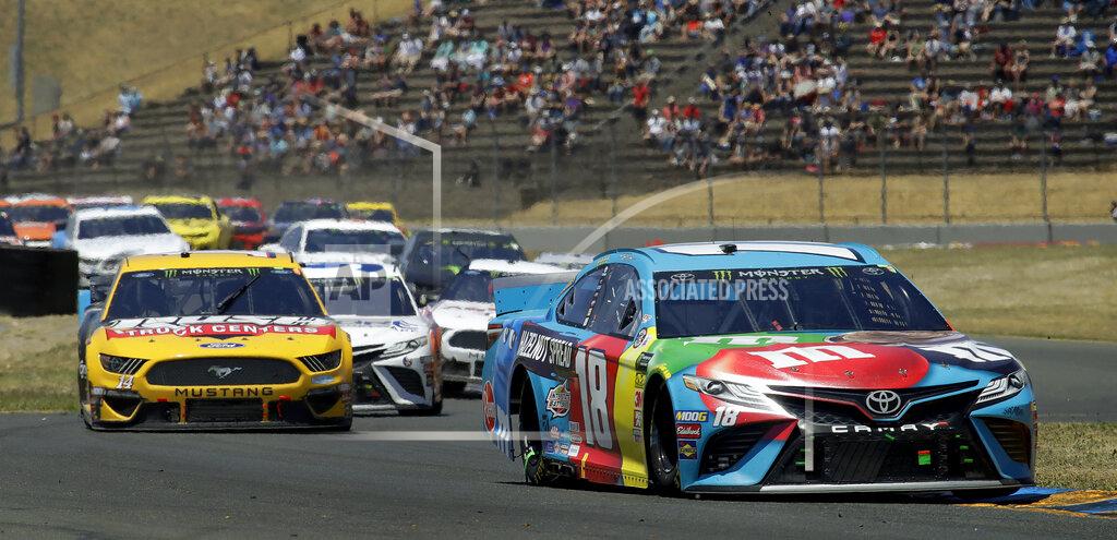 Ben Margot Kyle Busch (18) leads through a turn during a NASCAR Sprint Cup Series auto race Sunday, June 23, 2019, in Sonoma, Calif. (AP Photo/Ben Margot)