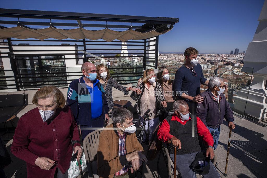 Manu Fernandez Residents of different nursing homes take their first excursion outside their care homes after been vaccinated, with the skyline of Madrid in the background in Madrid, Spain, Monday, March 15, 2021. The group are now fully protected from the deadly COVID-19 virus having received their vaccination a few weeks ago. The care home managers thought that it was time for them to enjoy a trip into central Madrid to take in the sights and stretch their legs. (AP Photo/Manu Fernandez)
