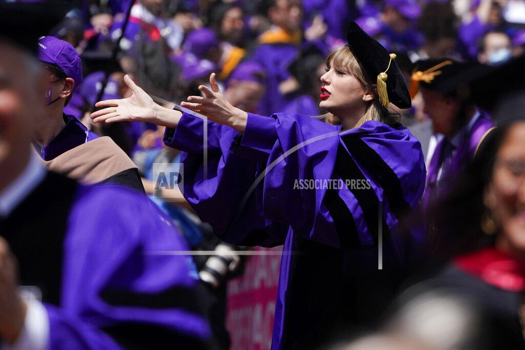 Seth Wenig Taylor Swift, center, blows kisses to graduates as she participates in a graduation ceremony for New York University at Yankee Stadium in New York, Wednesday, May 18, 2022. (AP Photo/Seth Wenig)