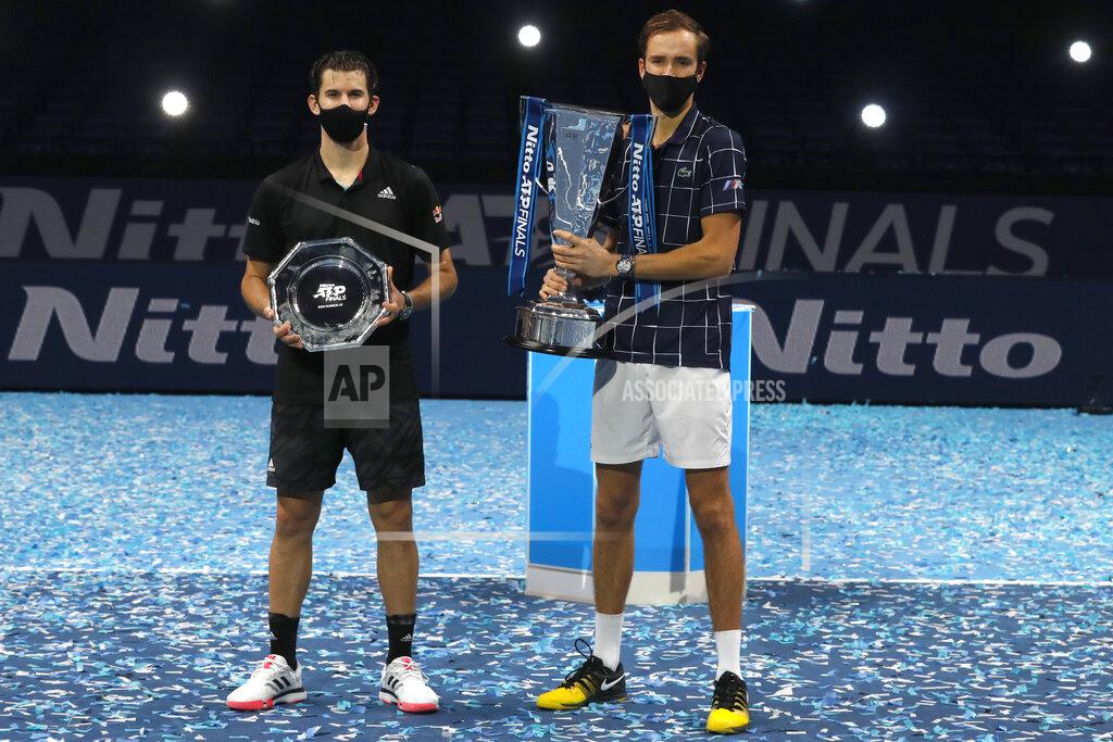 Frank Augstein Daniil Medvedev of Russia, right, holds up the winners trophy after defeating Dominic Thiem of Austria, left, in the final of the ATP World Finals tennis match at the ATP World Finals tennis tournament at the O2 arena in London, Sunday, Nov. 22, 2020. (AP Photo/Frank Augstein)