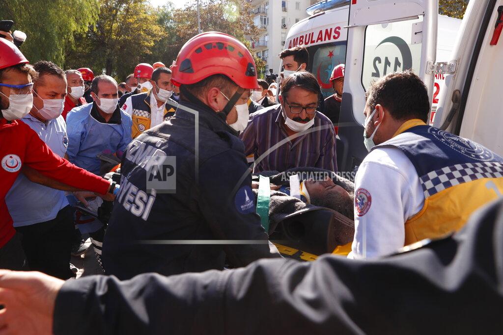 Darko Bandic Medics and rescue personnel carry into an ambulance an injured person from the debris of a collapsed building in Izmir, Turkey, Saturday, Oct. 31, 2020. Rescue teams on Saturday ploughed through concrete blocs and debris of eight collapsed buildings in Turkey's third largest city in search of survivors of a powerful earthquake that struck Turkey's Aegean coast and north of the Greek island of Samos, killing dozens Hundreds of others were injured. (AP Photo/Darko Bandic)