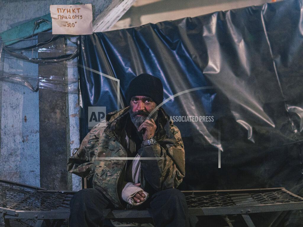 Dmytro 'ORest' Kozatskyi FILE - In this photo provided by Azov Special Forces Regiment of the Ukrainian National Guard Press Office, an Azov Special Forces Regiment's serviceman, injured during fighting against Russian forces, poses for a photographer inside the Azovstal steel plant in Mariupol, Ukraine, on May 10, 2022. The Ukrainian forces who made a determined last stand in a Mariupol steel mill against Russian troops were a mixture of seasoned soldiers, border guards, a controversial national guard regiment and volunteers who took up arms in the weeks before Russia's invasion. (Dmytro 'Orest' Kozatskyi/Azov Special Forces Regiment of the Ukrainian National Guard Press Office via AP)