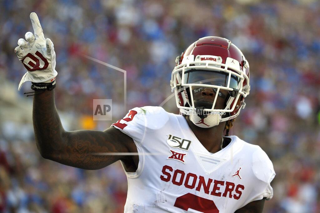 Mark J. Terrill Oklahoma wide receiver CeeDee Lamb celebrates after scoring a touchdown during the first half of the teaam's NCAA college football game against UCLA on Saturday, Sept. 14, 2019, in Pasadena, Calif. (AP Photo/Mark J. Terrill)