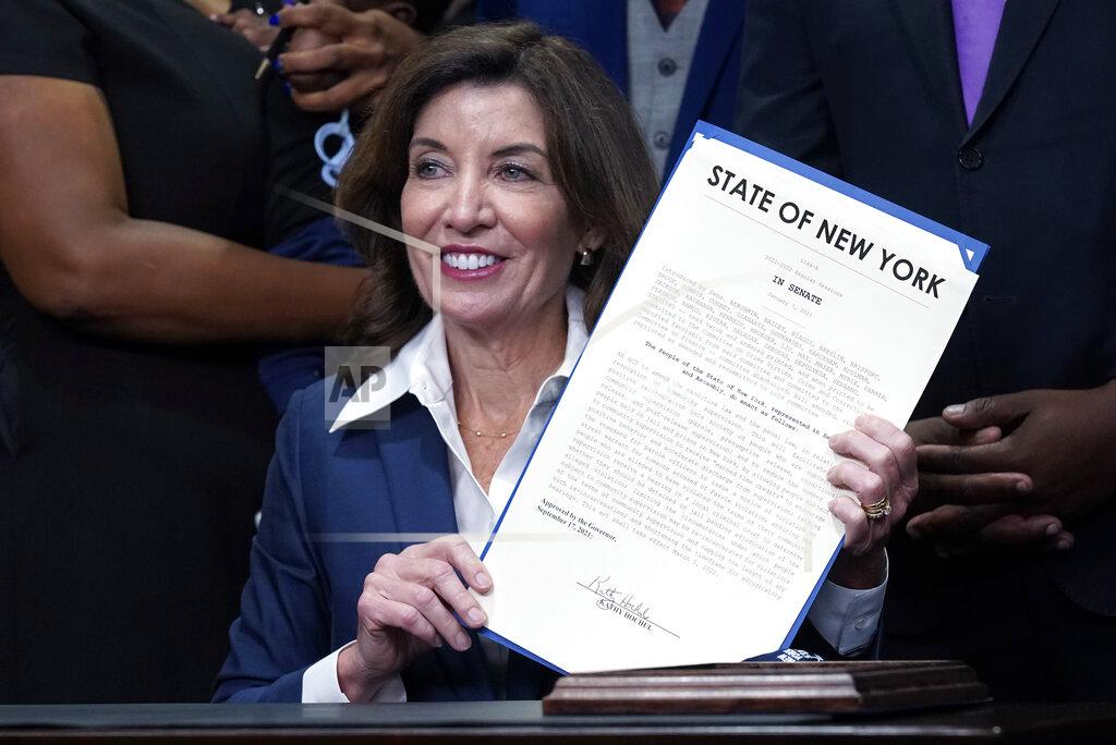Richard Drew New York Gov. Kathy Hochul holds the "Less is More" law she signed, during ceremonies in the her office, in New York, Friday, Sept. 17, 2021. New Yorkers will be able to avoid jail time for most nonviolent parole violations under a new law that will take effect in March, and largely eliminates New York's practice of incarcerating people for technical parole violations. (AP Photo/Richard Drew)