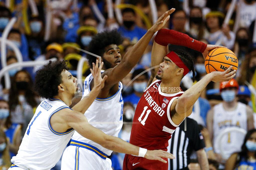 Ringo H.w. Chiu Stanford forward Jaiden Delaire (11) is defended by UCLA center Myles Johnson, center, and guard Jules Bernard (1) in the second half of an NCAA college basketball game Saturday, Jan. 29, 2022, in Los Angeles. (AP Photo/Ringo H.W. Chiu)