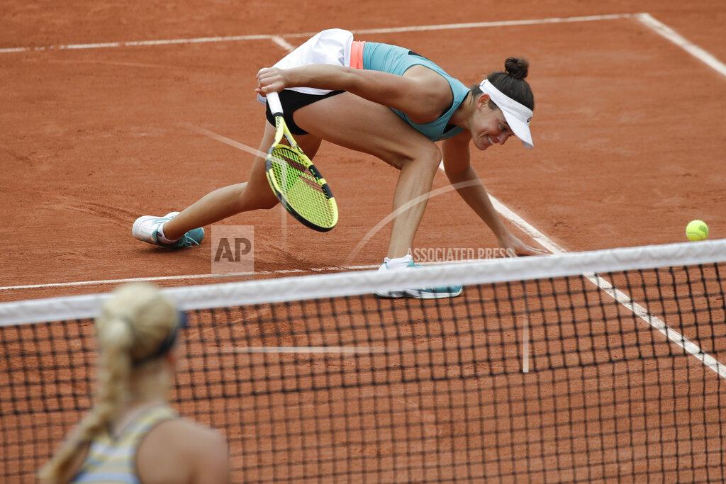 Alessandra Tarantino Jennifer Brady of the U.S. slides to play a shot against Denmark's Clara Tauson, left, in the first round match of the French Open tennis tournament at the Roland Garros stadium in Paris, France, Tuesday, Sept. 29, 2020. (AP Photo/Alessandra Tarantino)