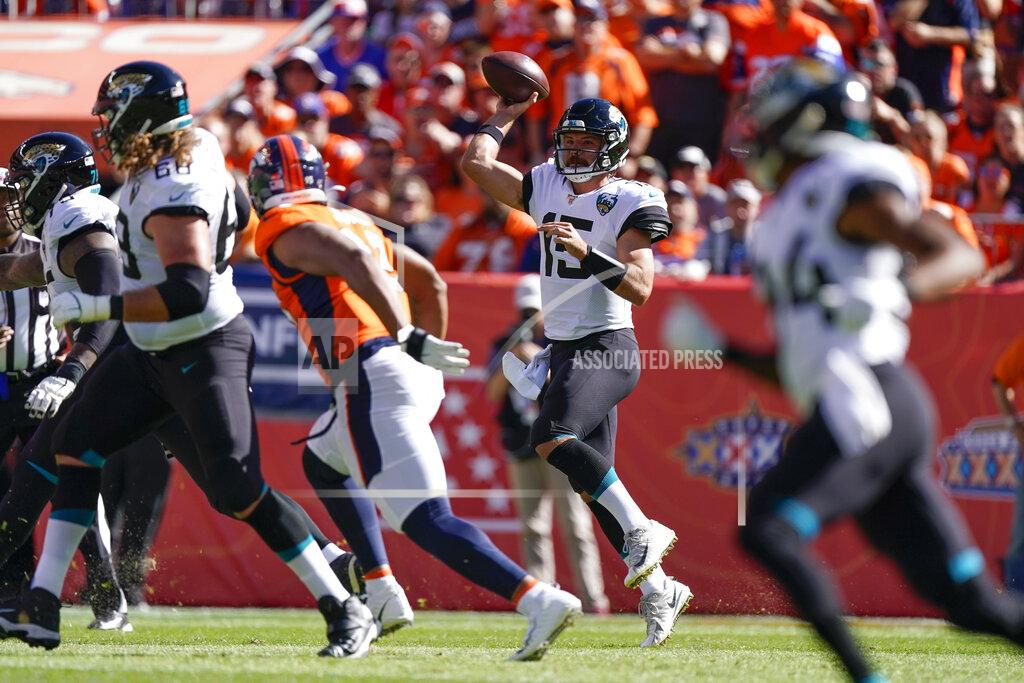 Jack Dempsey Jacksonville Jaguars quarterback Gardner Minshew, second from high scrambles during the first half of an NFL football game against the Denver Broncos, Sunday, Sept. 29, 2019, in Denver. (AP Photo/Jack Dempsey)