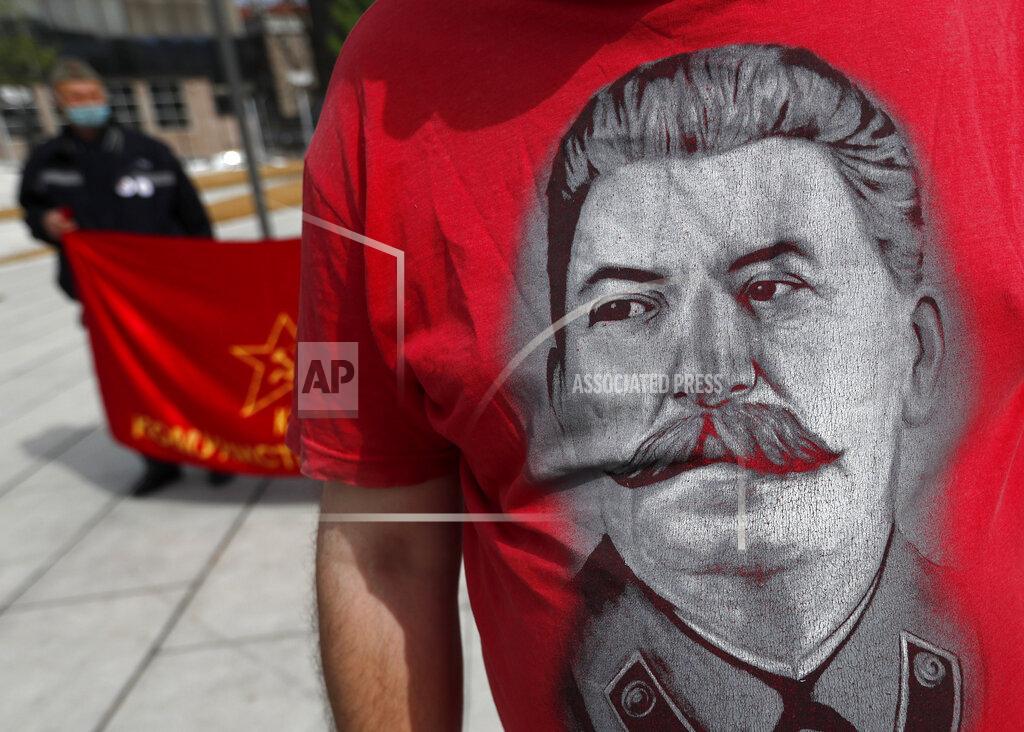 Darko Vojinovic A man wearing a shirt with the image of former Soviet dictator Joseph Stalin attends a May Day rally on International Workers Day in Belgrade, Serbia, Saturday, May 1, 2021. Activists marked May Day with defiant rally. (AP Photo/Darko Vojinovic)