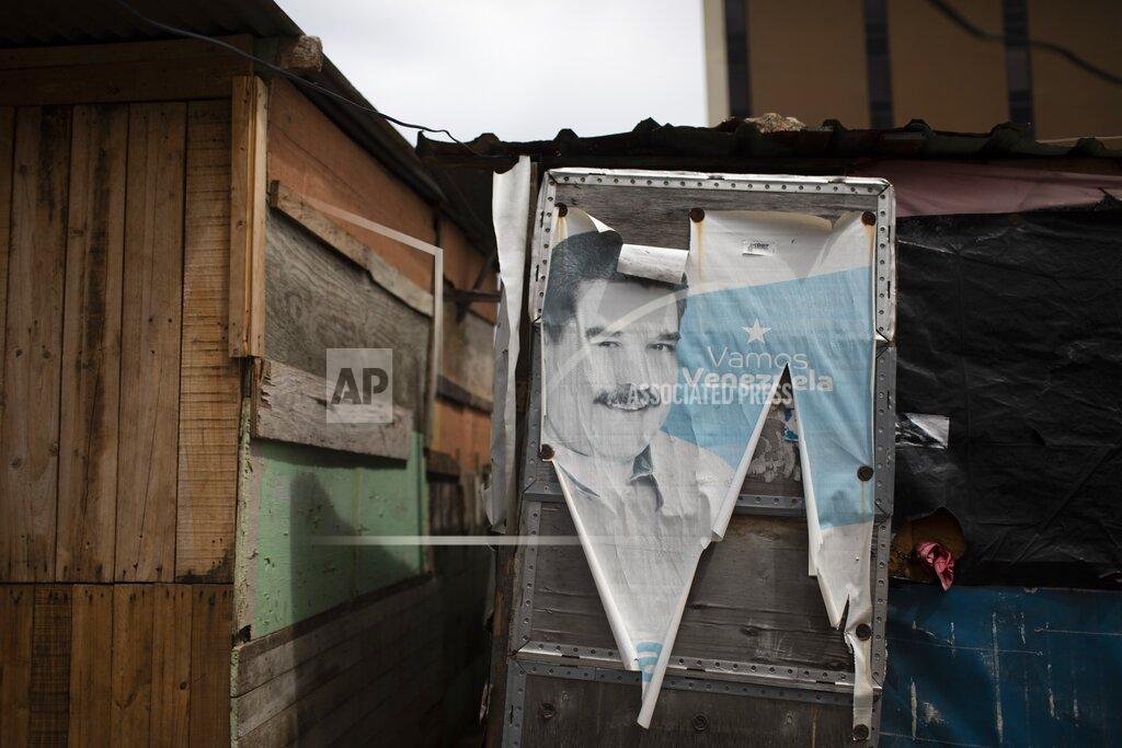 Ariana Cubillos FILE - In this July 7, 2020 file photo an old campaign poster featuring Venezuelan President Nicolas Maduro that reads in Spanish "Let's go Venezuela" covers the door of a shack home on occupied land in Caracas, Venezuela, amid a government-ordered lockdown to curb the spread of the new coronavirus. Venezuela President Nicolás Maduro is sure to seize on the U.S. election as an opening to attempt a fresh start to shattered relations with his most troublesome adversary, no matter who wins the White House. Neither President Donald Trump nor Joe Biden recognize Maduro as Venezuela's legitimate president but, in the runup to Election Day, the South American leader repeated his desire to reengage in talks. (AP Photo/Ariana Cubillos, File)