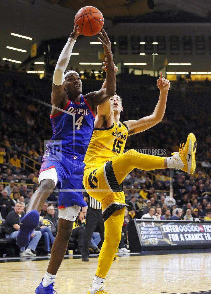 Charlie Neibergall DePaul forward Paul Reed (4) grabs a rebound in front of Iowa forward Ryan Kriener (15) during the second half of an NCAA college basketball game, Monday, Nov. 11, 2019, in Iowa City, Iowa. DePaul won 93-78. (AP Photo/Charlie Neibergall)