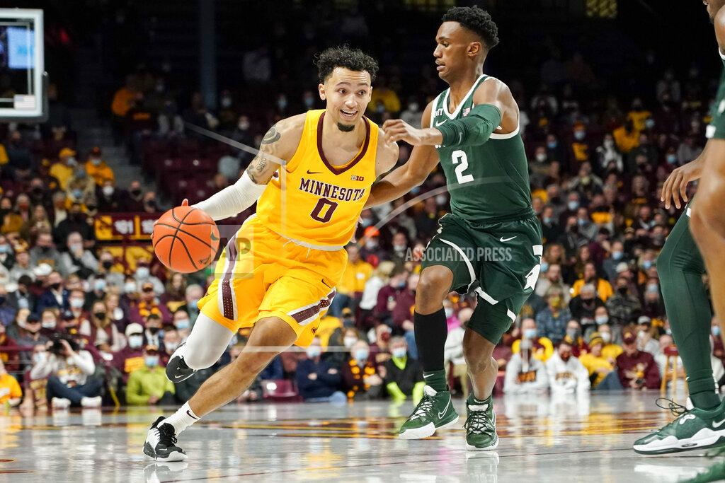 Craig Lassig Minnesota guard Payton Willis (0) drives past Michigan State guard Tyson Walker during the first half an NCAA college basketball game Wednesday, Dec. 8, 2021, in Minneapolis. (AP Photo/Craig Lassig)