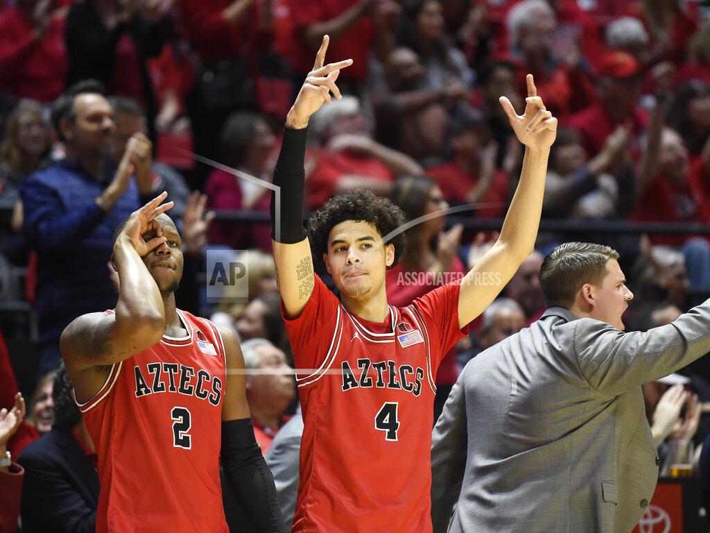 Denis Poroy San Diego State guard Adam Seiko (2) and guard Trey Pulliam (4) celebrate during the second half of an NCAA college basketball game against Nevada, Saturday, Jan. 18, 2020, in San Diego. (AP Photo/Denis Poroy)