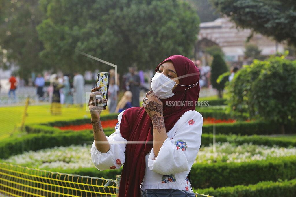 Mucahid Yapici A woman takes selfie photos at the iconic Sultan Ahmed Mosque, better known as the Blue Mosque, in the historic Sultan Ahmed district of Istanbul, Tuesday, July 20, 2021. Thousands of Muslims attended dawn Eid al-Adha prayers at the the iconic Haghia Sophia and Blue Mosque in Istanbul. (AP Photo/Mucahid Yapici)