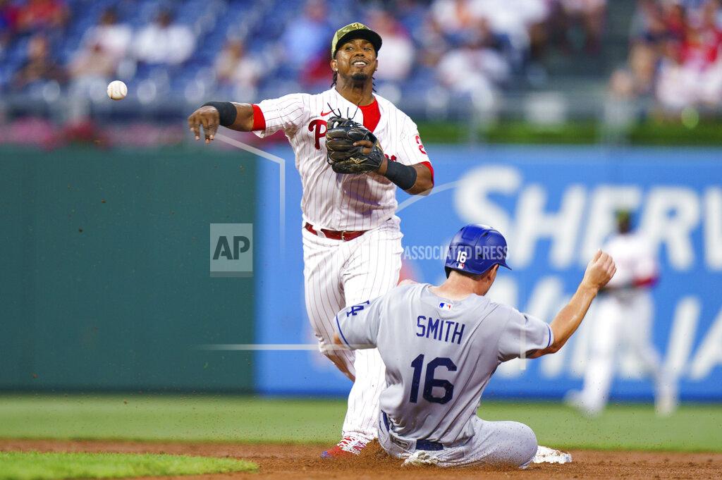 Chris Szagola Philadelphia Phillies second baseman Jean Segura throws to first after forcing out Los Angeles Dodgers' Will Smith during the third inning of a baseball game, Friday, May 20, 2022, in Philadelphia. Chris Taylor was out at first. (AP Photo/Chris Szagola)