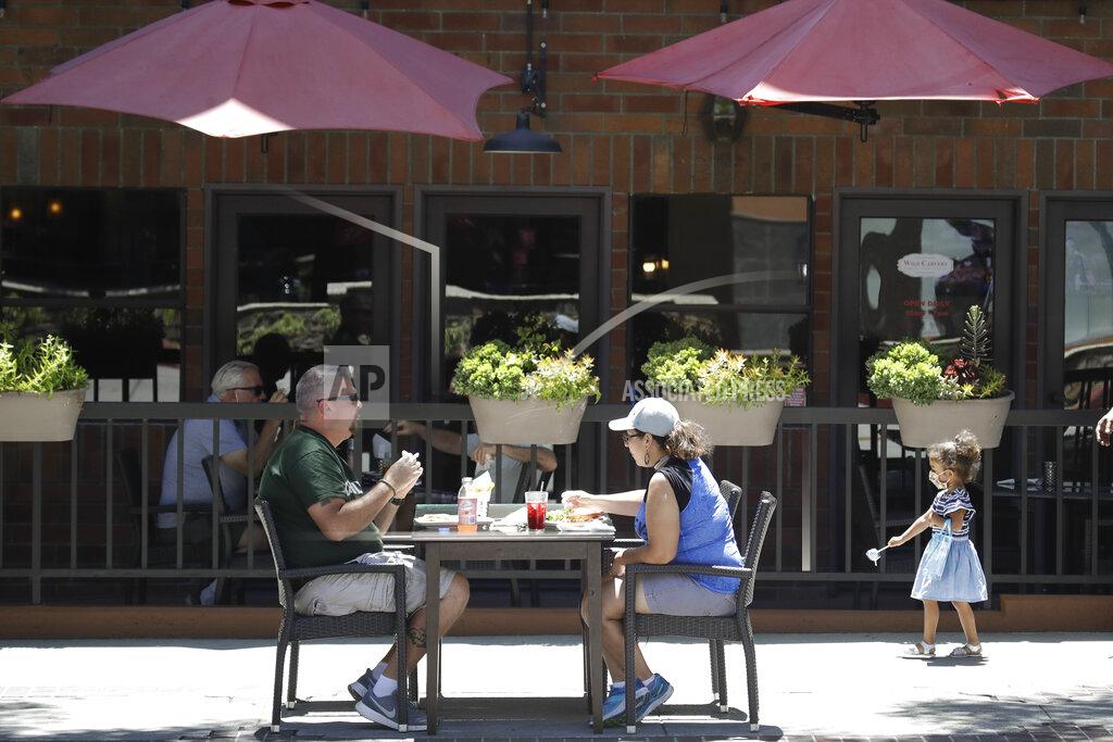 Marcio Jose Sanchez FILE - In this July 18, 2020 file photo, patrons eat at a table set up on a sidewalk in Burbank, Calif. California's financially battered restaurants filed government claims Monday to recover more than $100 million in fees for liquor and health permits and tourism charges that they say were assessed even though their businesses were shuttered or only partially operating under long-running coronavirus orders. Few industries have been hit as hard during the pandemic as restaurants. (AP Photo/Marcio Jose Sanchez, File)