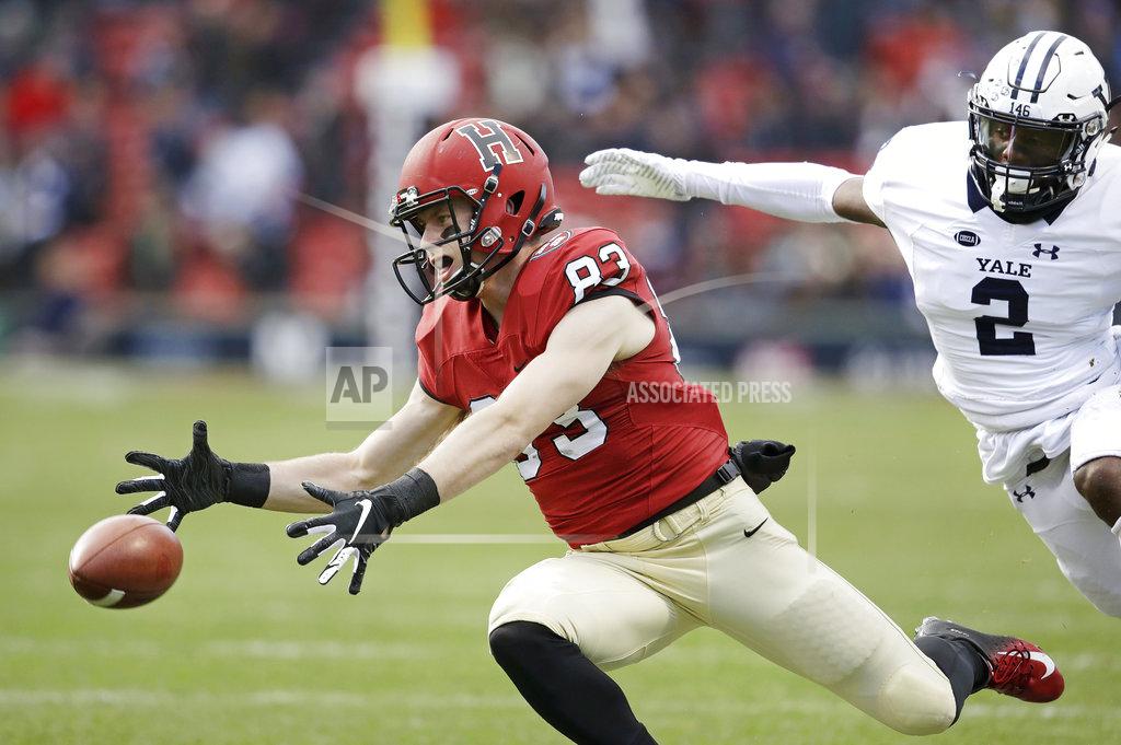 Charles Krupa Harvard wide receiver Jack Cook (83) reaches for a pass, which he did not complete, as Yale defensive back Marquise Peggs (2) gives chase during the first half an NCAA college football game at Fenway Park in Boston, Saturday, Nov. 17, 2018. (AP Photo/Charles Krupa)
