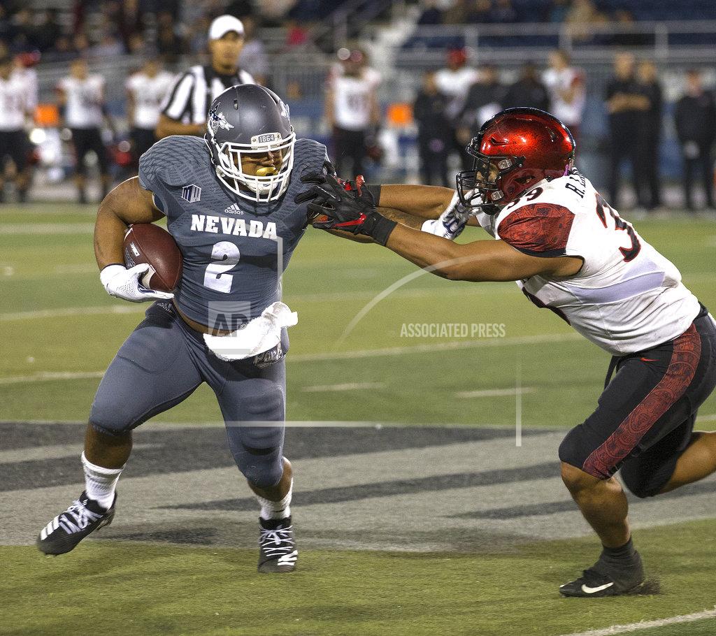 Tom R. Smedes Nevada running back (2) straight-arms San Diego State's Ronley Lakalaka (39) in the second half of an NCAA college football game in Reno, Nev., Saturday, Oct. 27, 2018. (AP Photo/Tom R. Smedes)