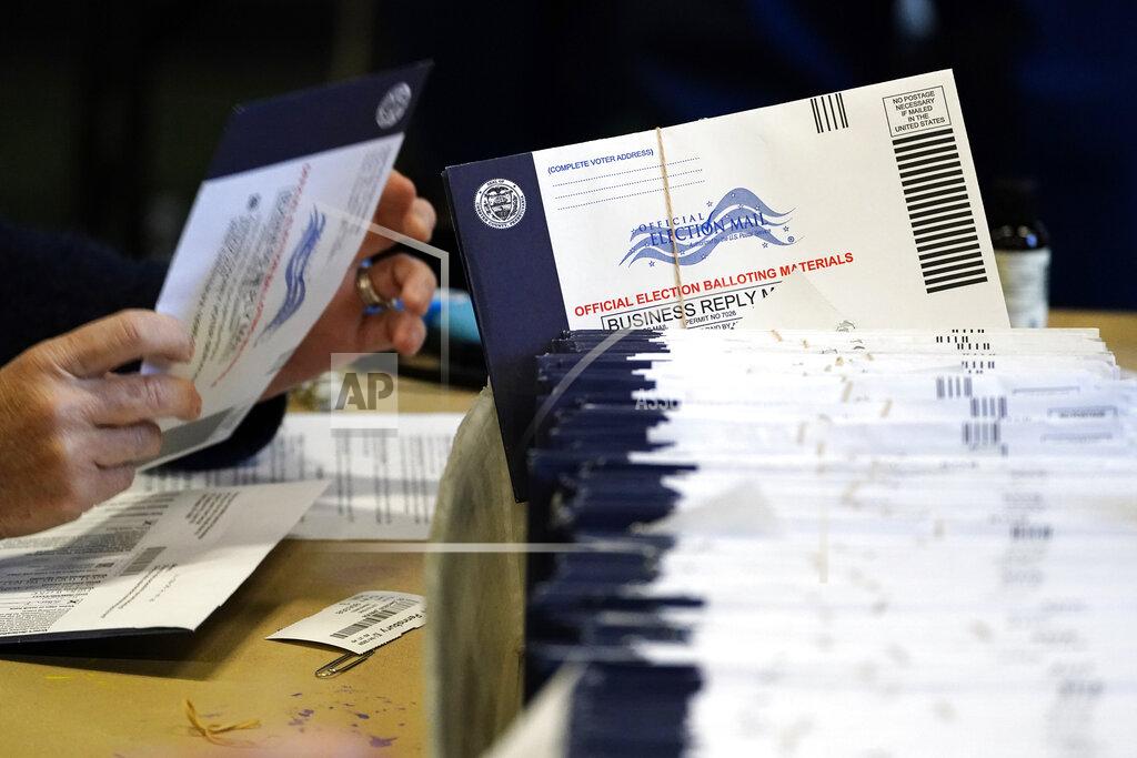 Matt Slocum FILE - In this Nov. 4, 2020, file photo, Chester County, Pa. election workers process mail-in and absentee ballots at West Chester University in West Chester. Democrats plan to move quickly on one of the first bills of the new Congress, which would set federal election standards. The For the People Act would require states to offer early voting, same-day registration and the option of absentee voting for all registered voters. (AP Photo/Matt Slocum, File)