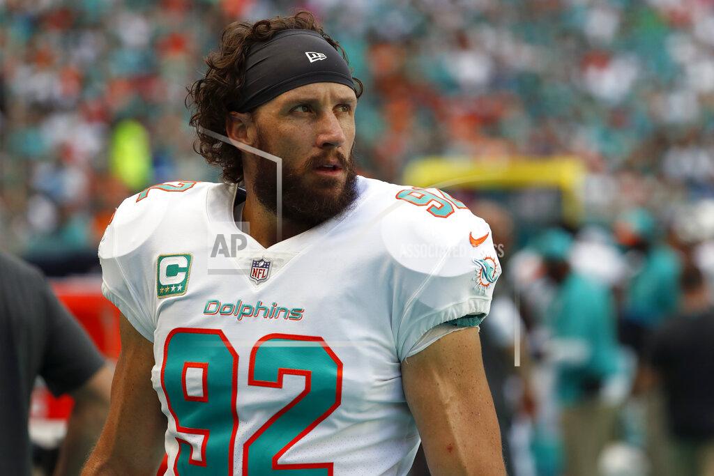 Wilfredo Lee FILE - In this Oct. 21, 2018, file photo, Miami Dolphins long snapper John Denney (92) is shown on the sidelines during the first half of an NFL football game against the Detroit Lions in Miami Gardens, Fla. Long snapper John Denney has been released after 14 seasons with the Miami Dolphins. Denney, 40, had been with the team longer than any other current player, but on Monday, Sept. 2, 2019, he became part of the Dolphins' purge of veterans. (AP Photo/Wilfredo Lee, File)