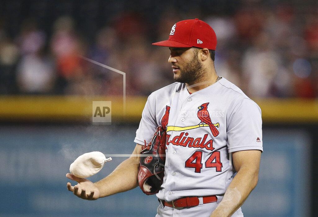 Ross D. Franklin FILE - In this Sept. 25, 2019, file photo, St. Louis Cardinals relief pitcher Junior Fernandez flips the rosin bag during the sixth inning of the team's baseball game against the Arizona Diamondbacks in Phoenix. Pitchers will use their own personal rosin bags this season. (AP Photo/Ross D. Franklin, File)