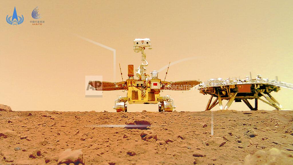 Uncredited In this image released by the China National Space Administration (CNSA) on Friday, June 11, 2021, the Chinese Mars rover Zhurong is seen near its landing platform taken by a remote camera that was dropped into position by the rover. China on Friday released a series of photos taken by its Zhurong rover on the surface of Mars, including one of the rover itself taken by a remote camera. (CNSA via AP)