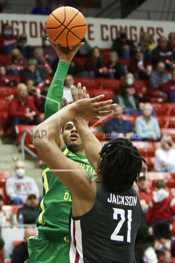 Young Kwak Oregon guard Rivaldo Soares, left, shoots over Washington State center Dishon Jackson during the second half of an NCAA college basketball game, Saturday, March 5, 2022, in Pullman, Wash. Washington State won 94-74. (AP Photo/Young Kwak)