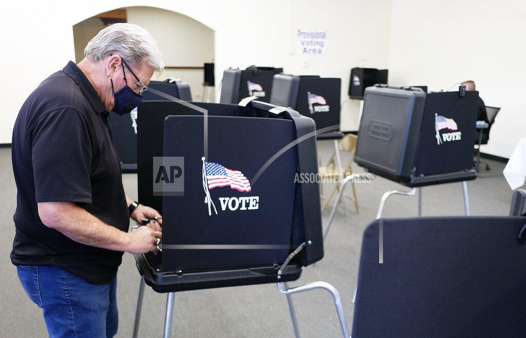 Adolphe Pierre-Louis Robert Michael Smith casts his ballot at the Bernalillo County Annex located near downtown Albuquerque , N.M., as early voting begins, Tuesday, May 4, 2021, for the special election to replace the Congressional District One seat vacated by former U.S. Rep. Deb Haaland. (Adolphe Pierre-Louis/The Albuquerque Journal via AP)