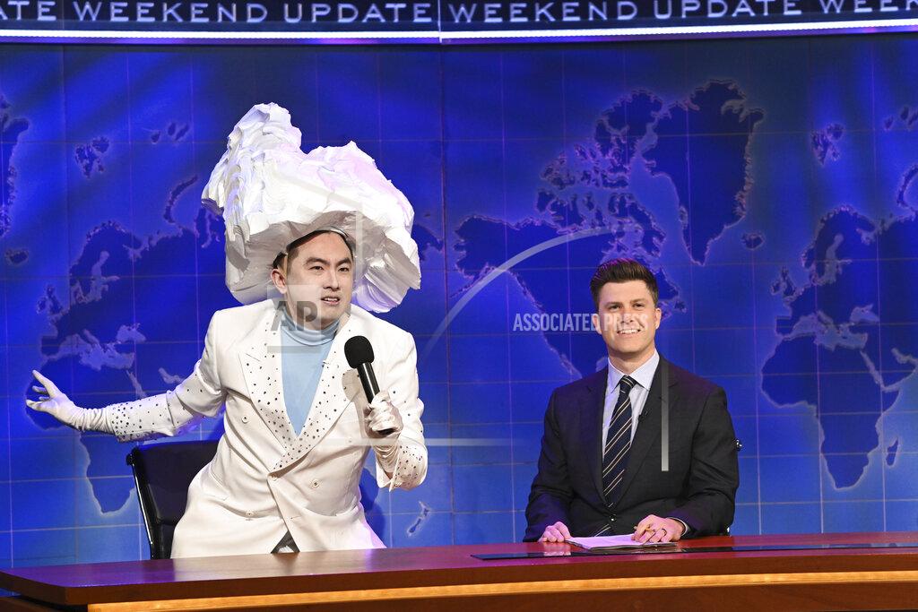 Will Heath This image released by NBC shows Bowen Yang as The Iceberg That Sank The Titanic, left, and anchor Colin Jost during Weekend Update on "Saturday Night Live" in New York on April 10, 2021. Yank is nominated for an Emmy Award for outstanding supporting actor in a comedy series. (Will Heath/NBC via AP)