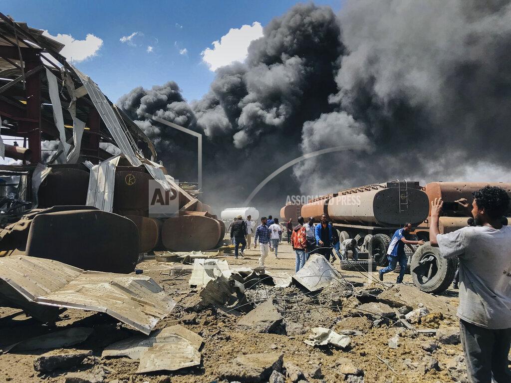 Uncredited FILE - In this Wednesday, Oct. 20, 2021 file photo, smoke from fires billows at the scene of an airstrike in Mekele, the capital of the Tigray region of northern Ethiopia Wednesday, Oct. 20, 2021. Aid workers say Ethiopian military airstrikes have forced a United Nations humanitarian flight to abandon its landing in the capital of the country’s Tigray region. A government spokesman confirms that authorities had been aware of the inbound flight. The development appears to be a sharp escalation in the intimidation tactics that authorities have used against aid workers amid the intensifying, year-long Tigray war. (AP Photo, File)